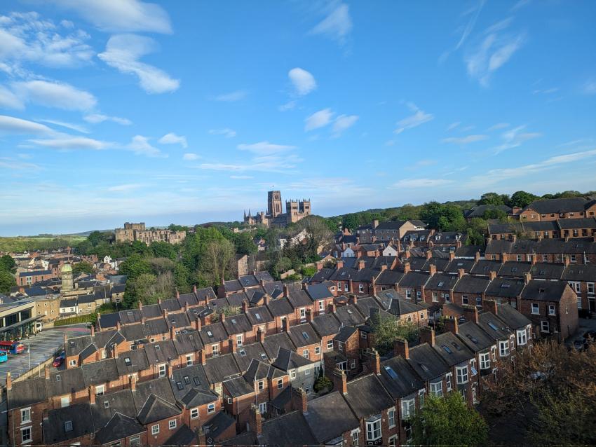 houses with imposing cathedral in the background against blue sky