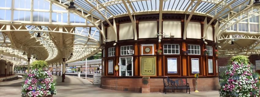 Station concourse with flowers and ornate glass ceiling