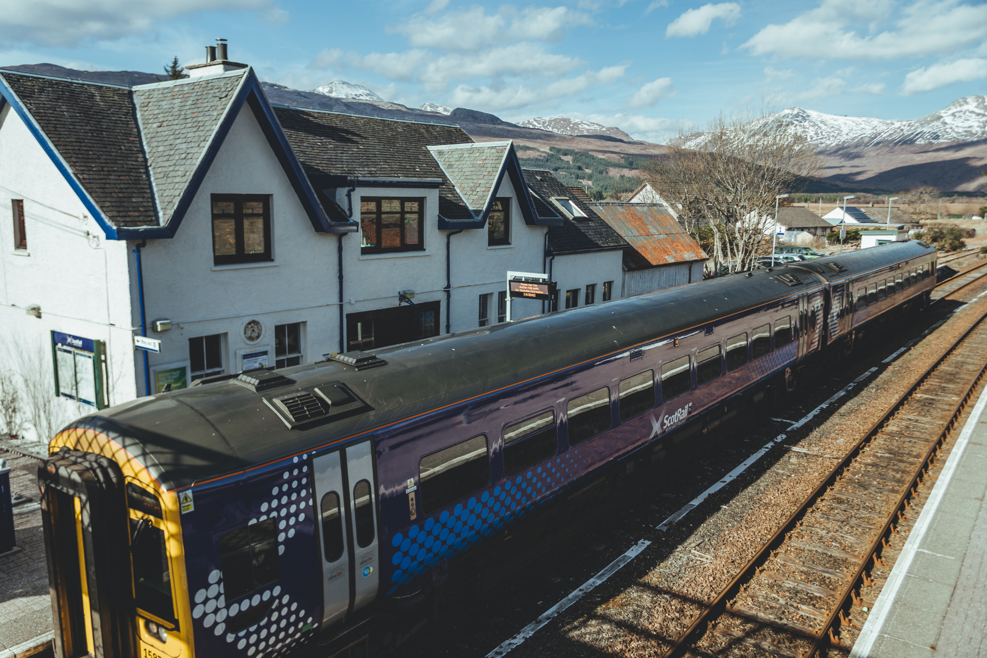 Train at station with mountainous views in the background