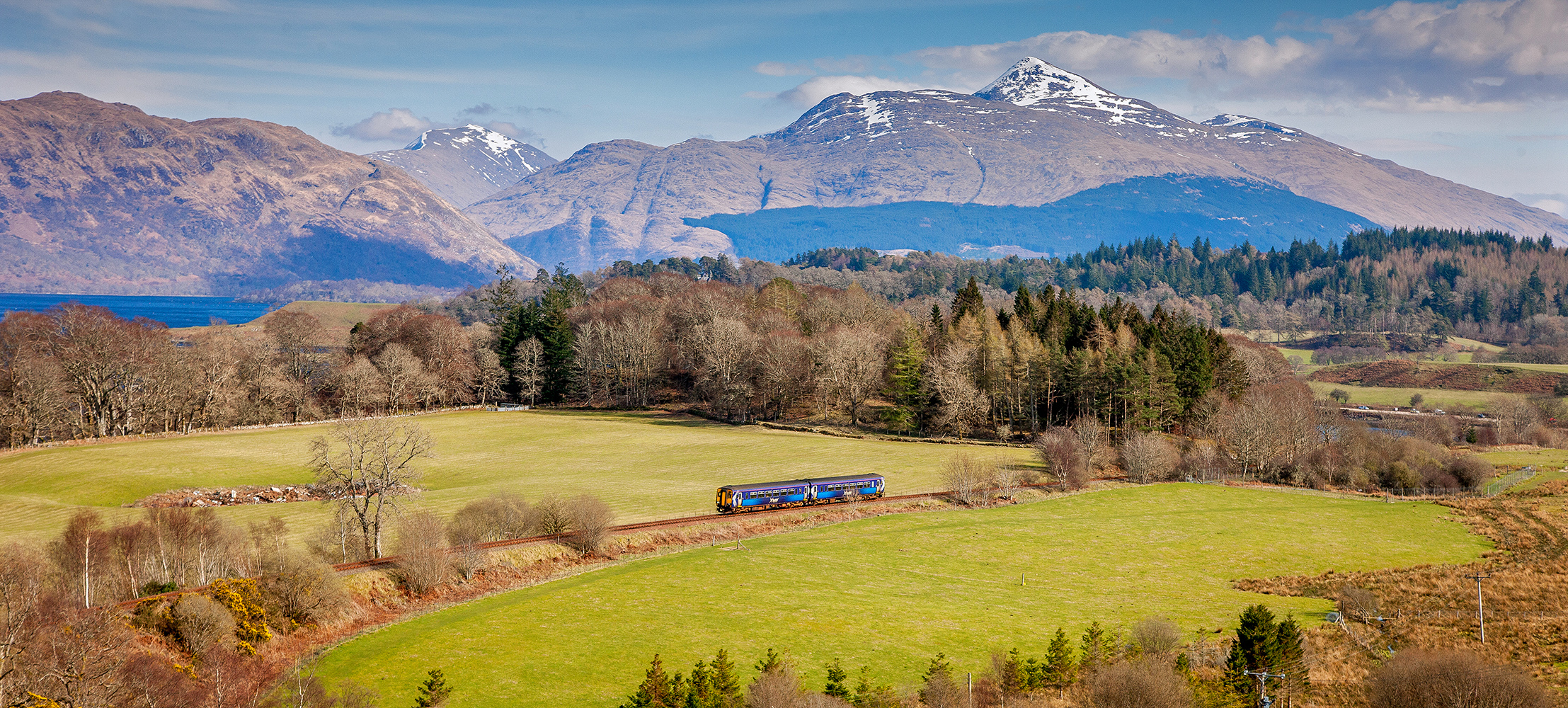 Train on the West Highland Line with mountains in the background