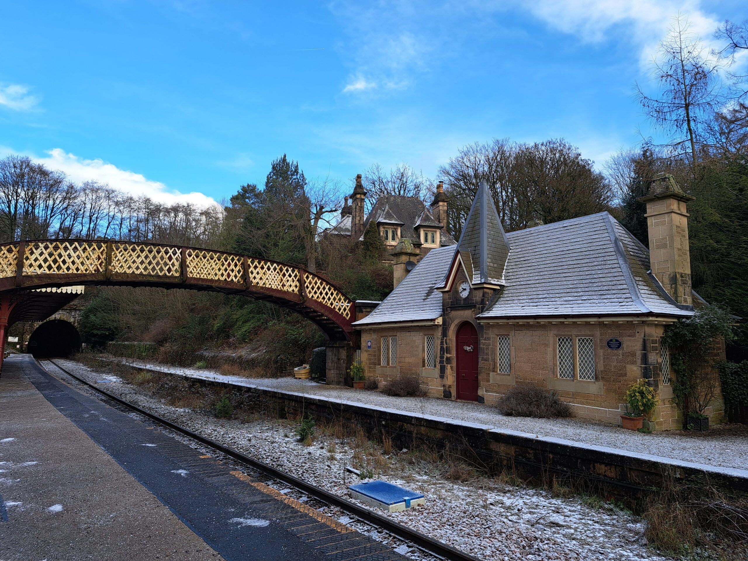 Cromford station with a layer of frost covering the bridge and station building