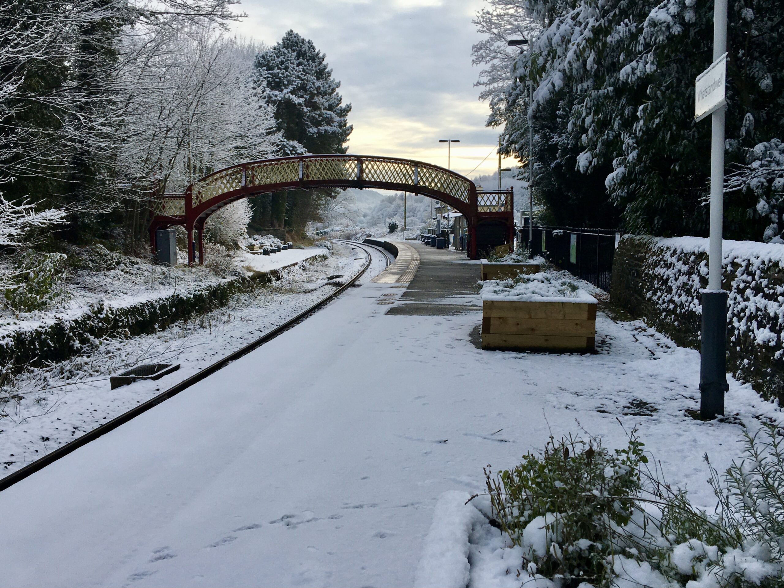 Whatstandwell station along the Derwent Valley Line looking frosty as it's covered in snow during winter