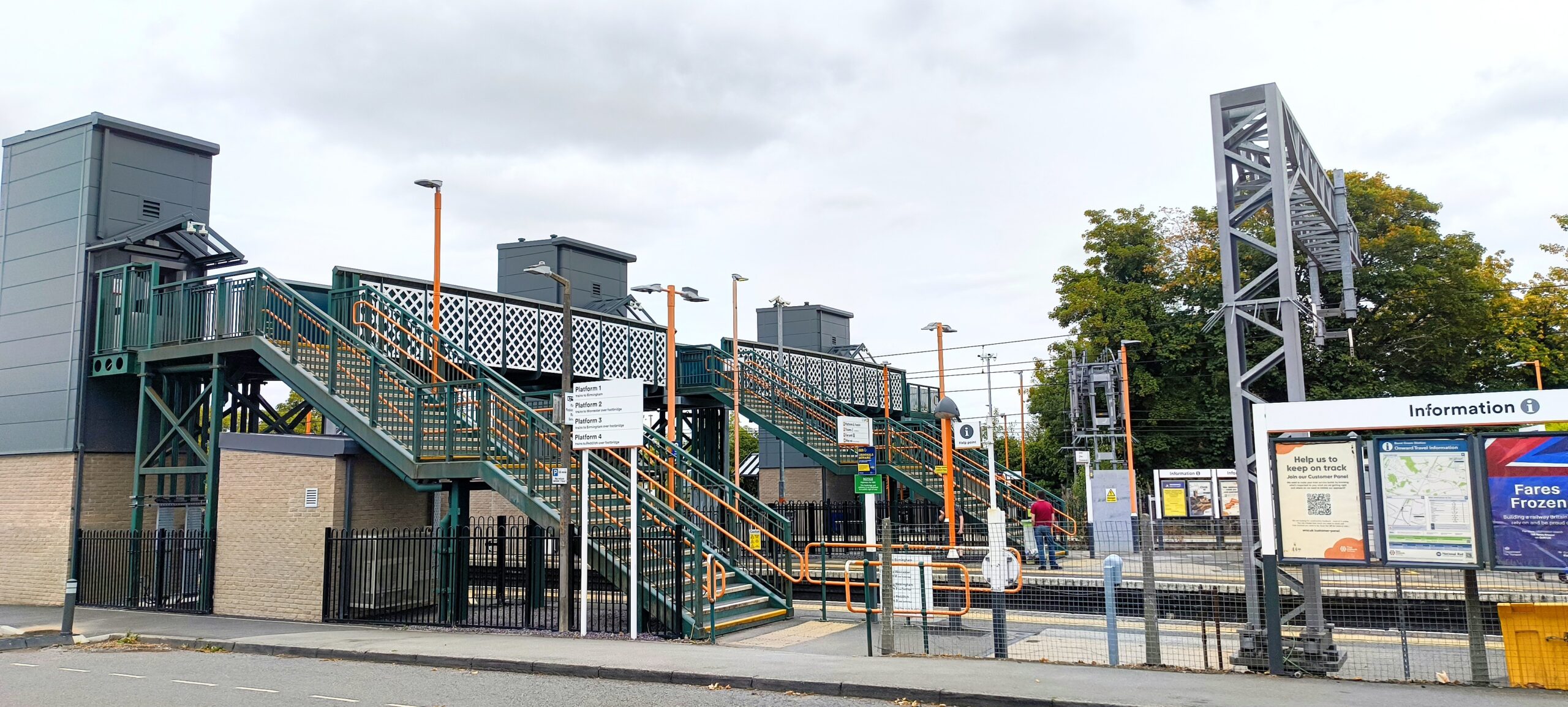 View from platform at Barnt Green Station showing the station information boards, stairs and signage. Along the Arrow Valley Line