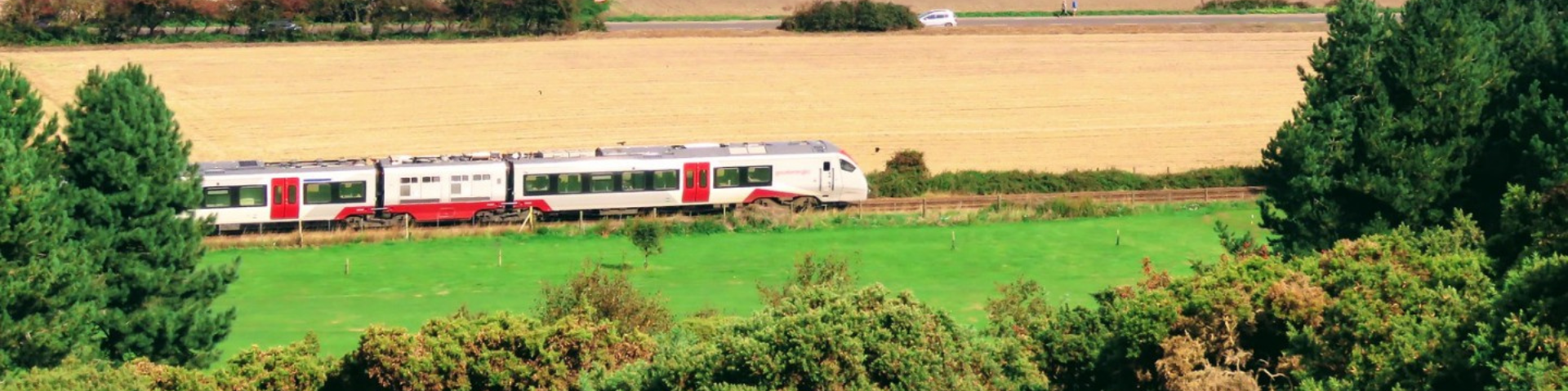 Bittern Line train travelling through fields