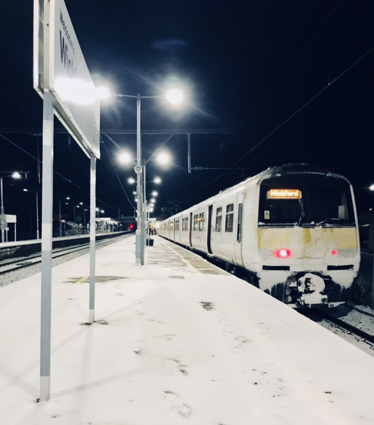 Train at station in winter with snow