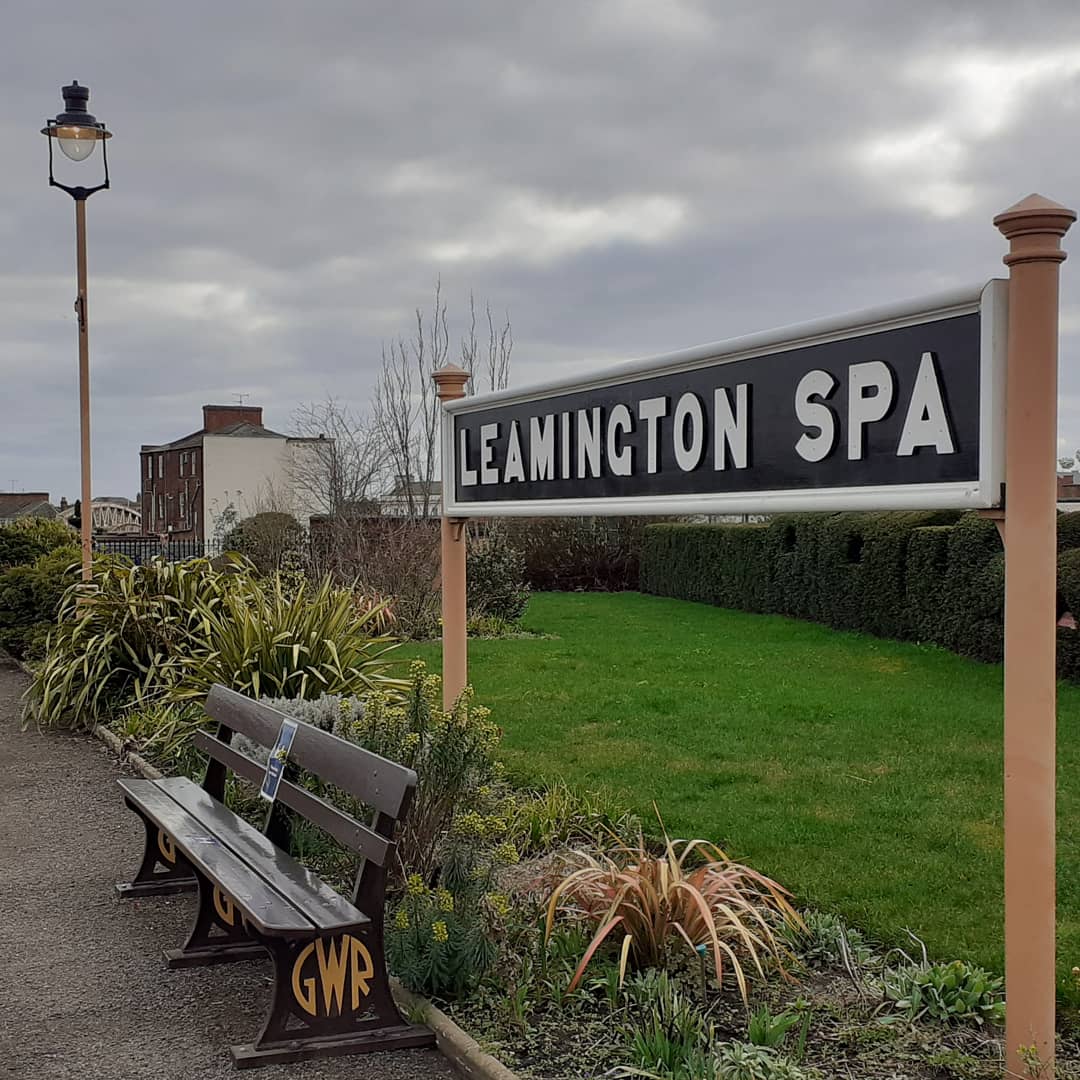 Leamington Spa Railway Station with bench and flowerbeds