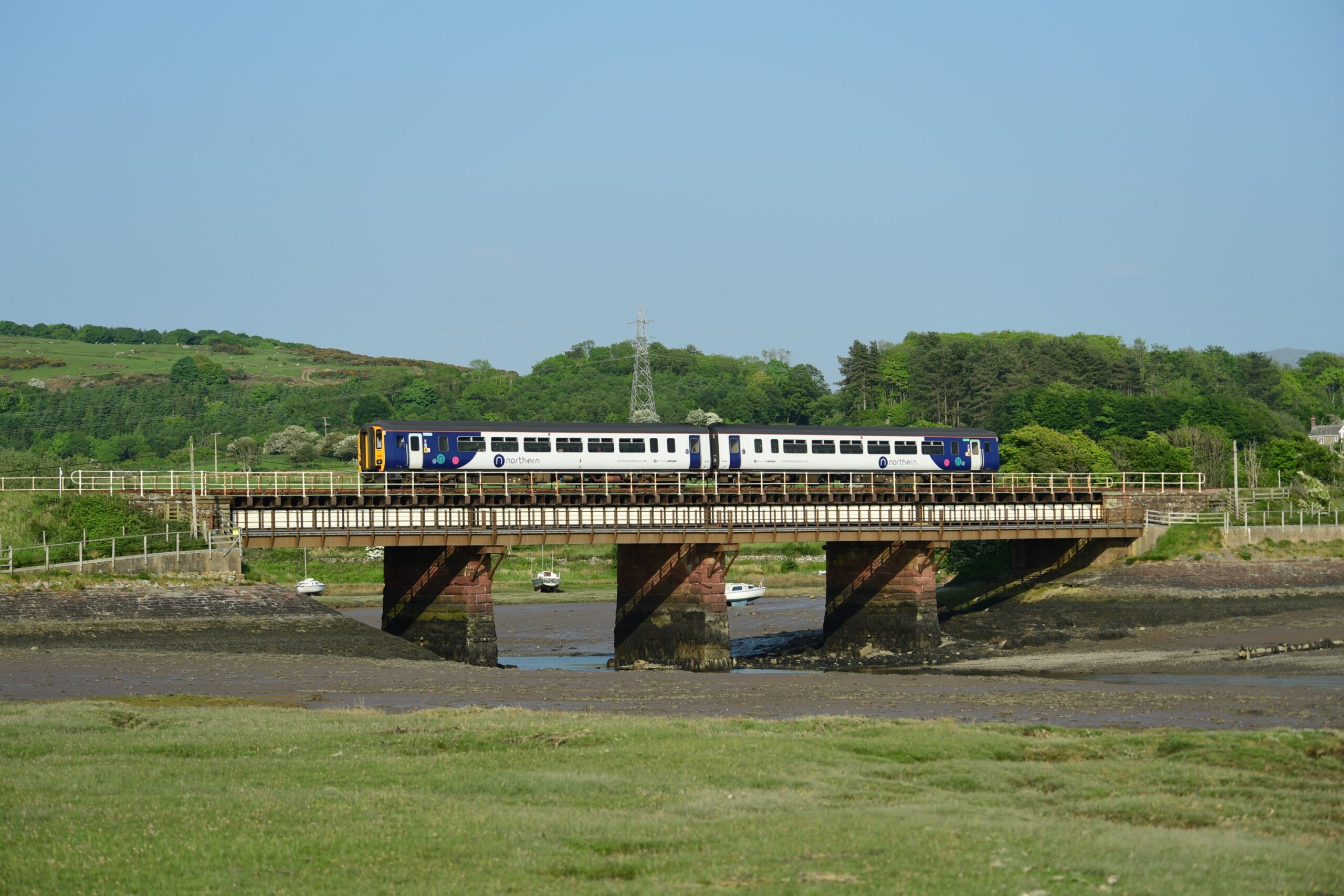 Northern train travelling along the Cumbrian Coast at Ravenglass