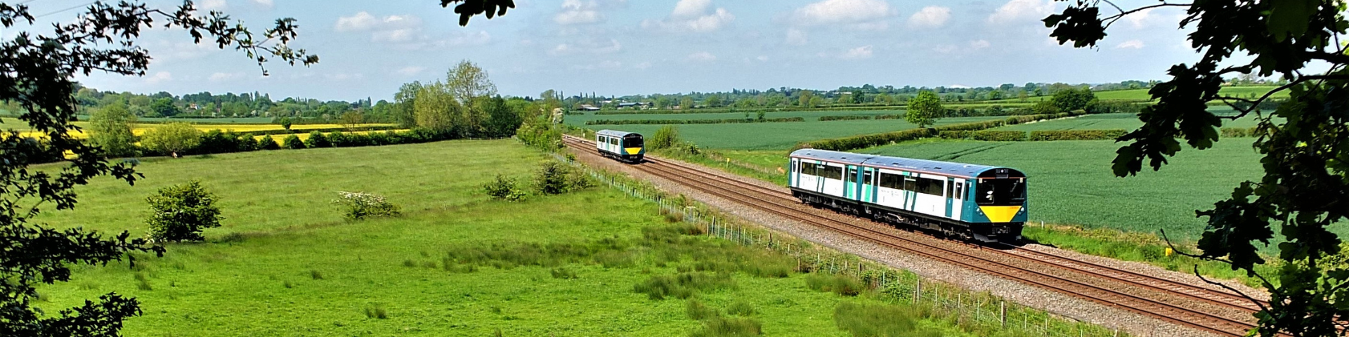 Marston Vale train travelling through lush countryside on a sunny day