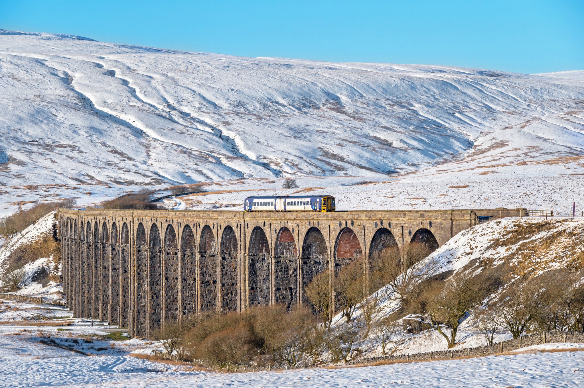 Train travelling along Ribblehead Viaduct in the snow | Scenic Rail Winter