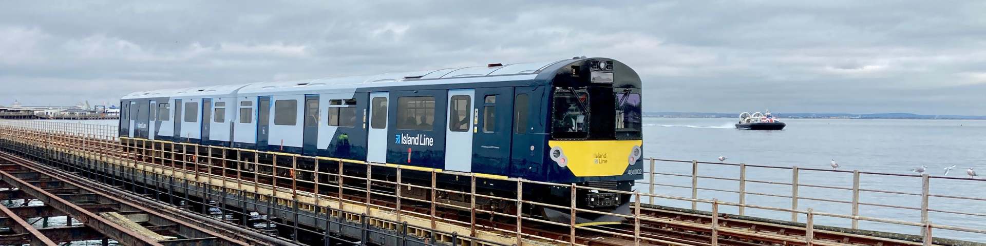 Island Line train travelling by the side of open water on the Isle of Wight