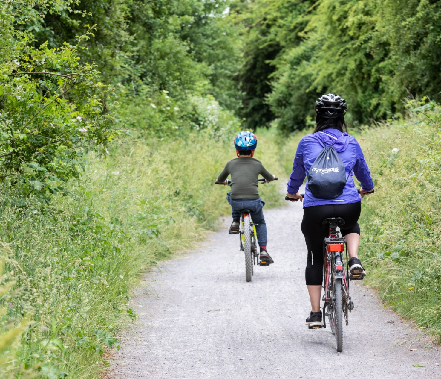 Family riding bikes along the Strawberry Line