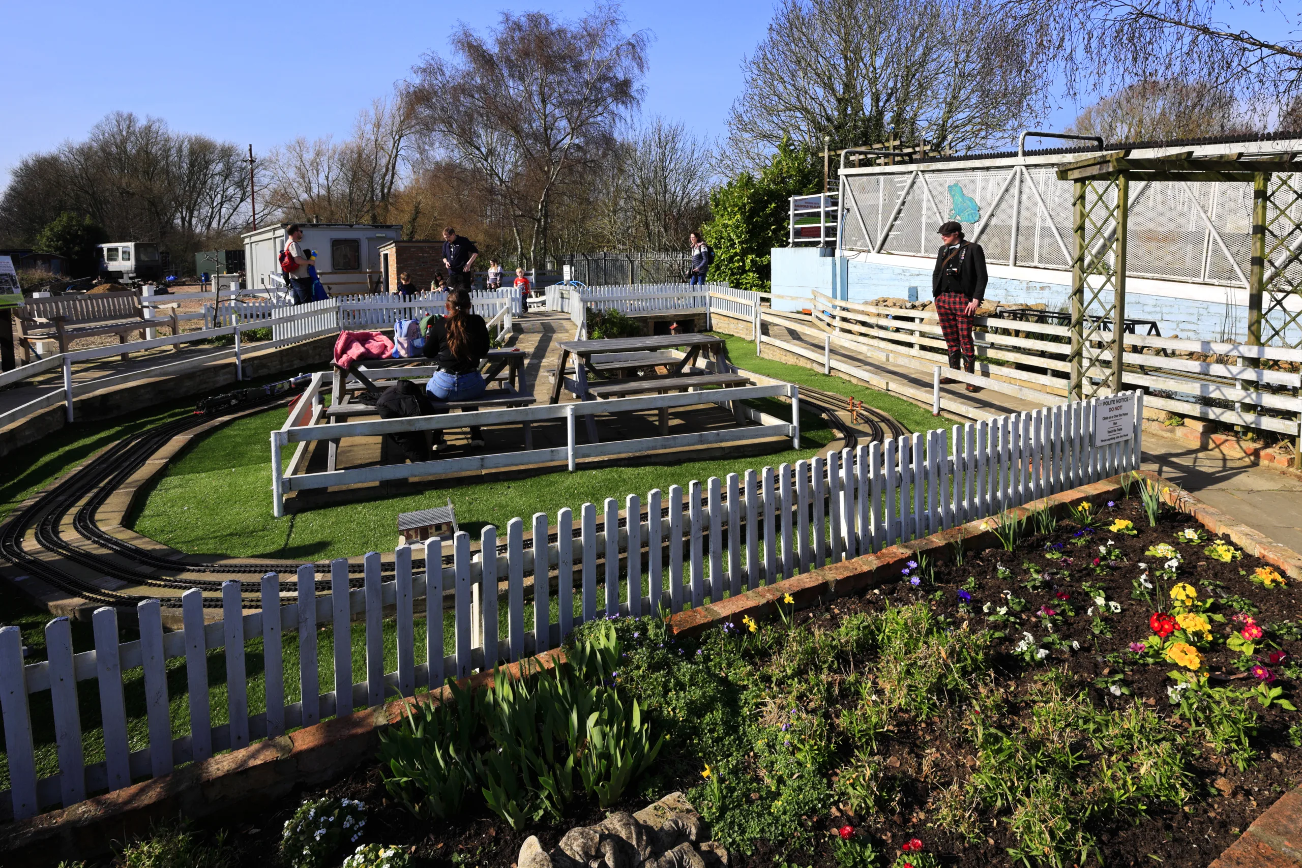 People looking at miniature railway outside