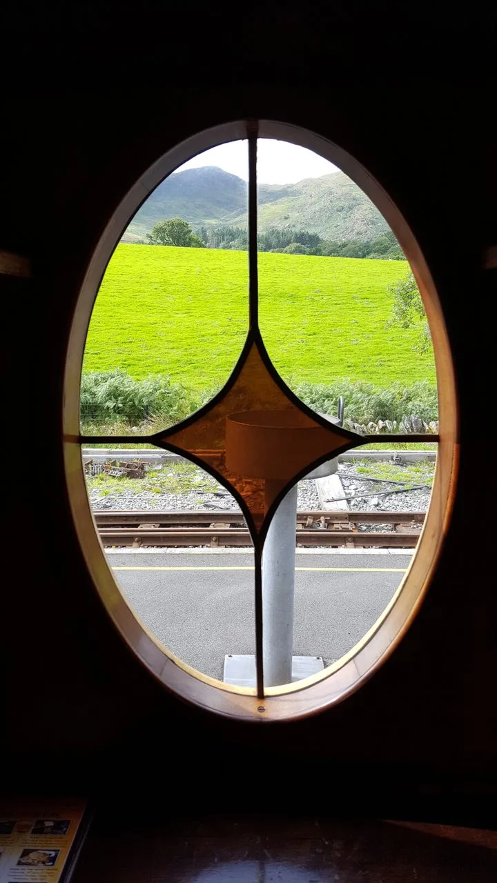 View from an ornate train window of the tracks beyond | scenic rail views