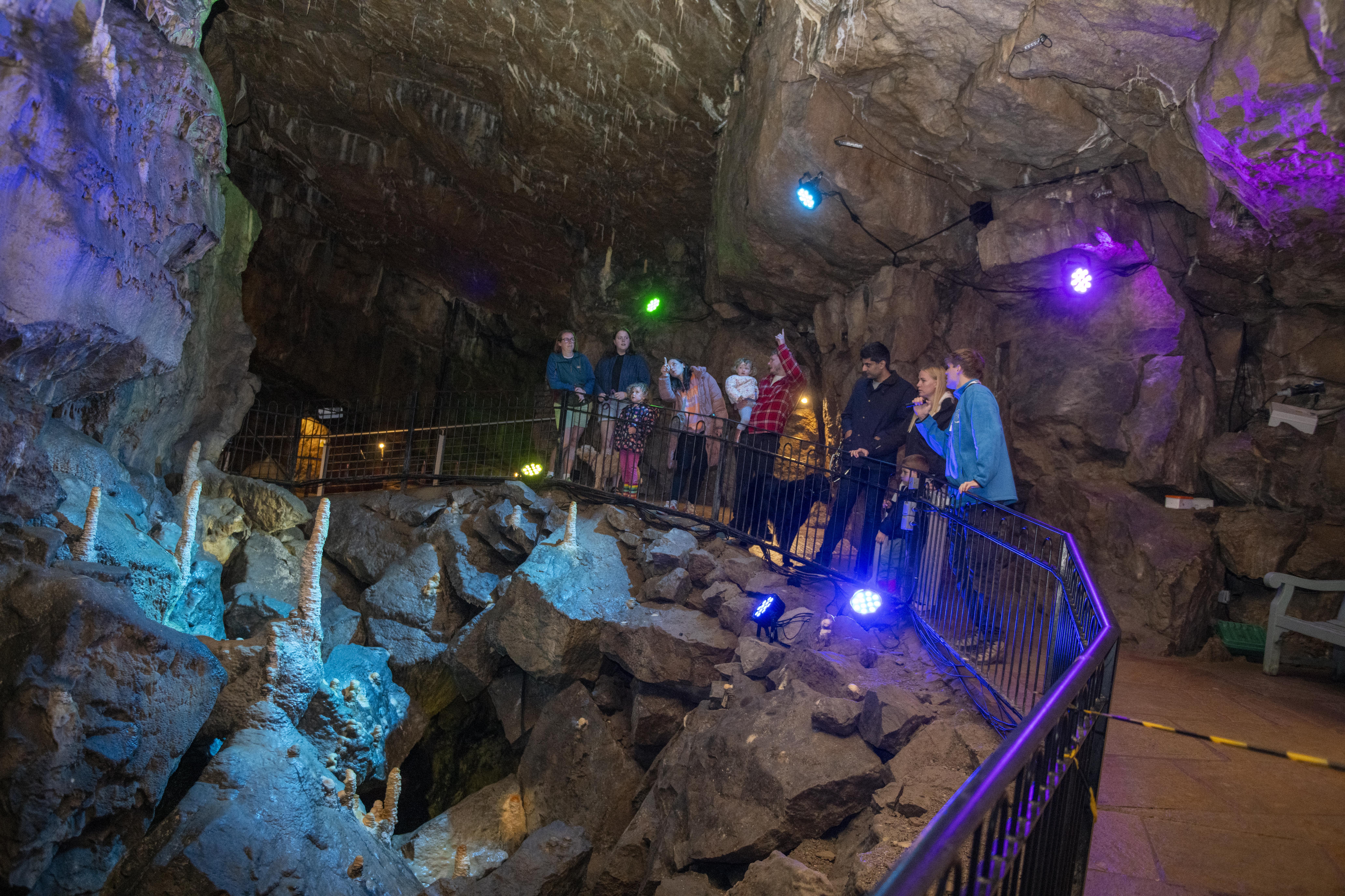 Group in cave looking at the natural rock formations. Photo: Buxton Civic Association