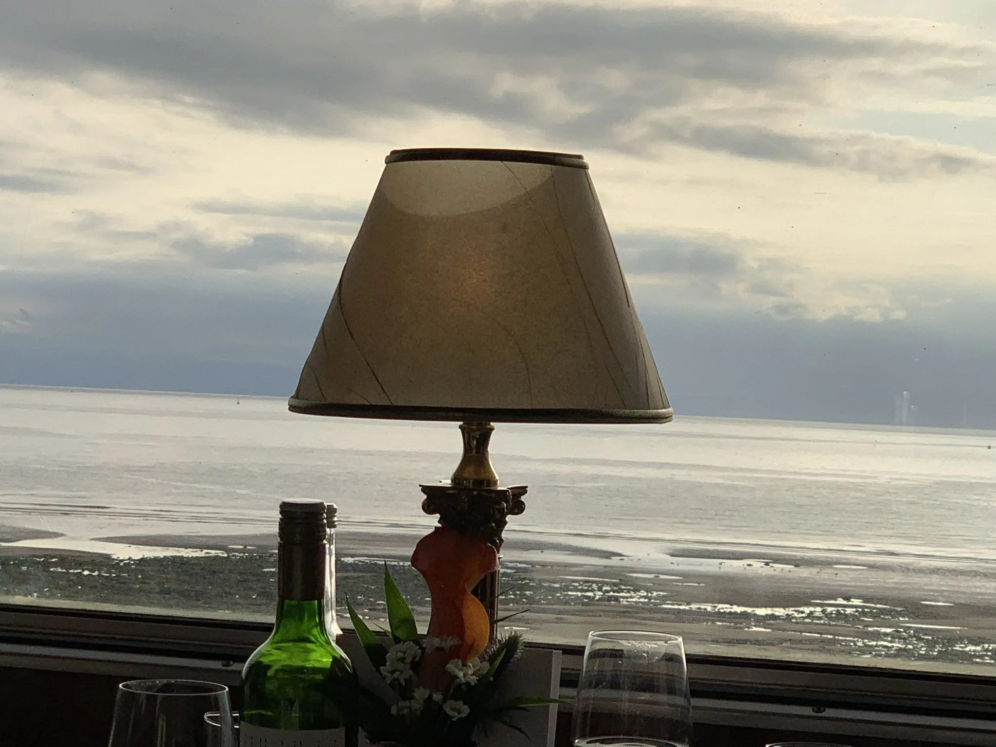 View from the train of the sea with a lamp on the train table in the foreground