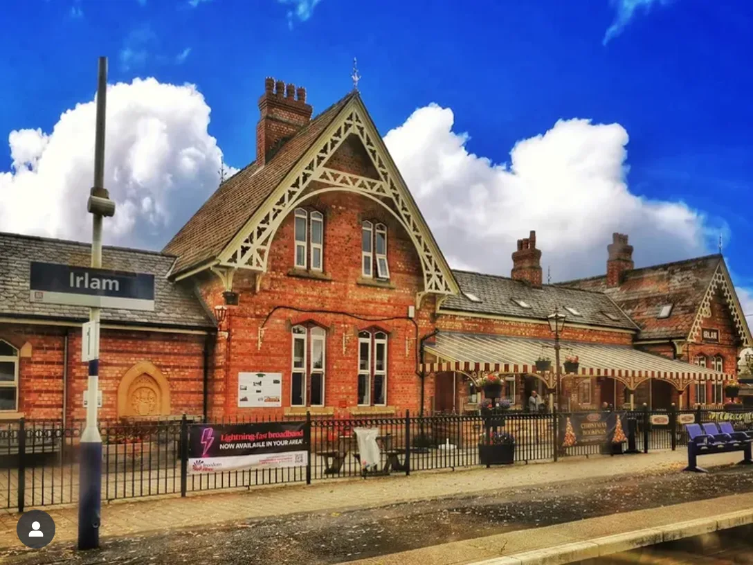 View of red brick station building at Irlam | scenic rail views