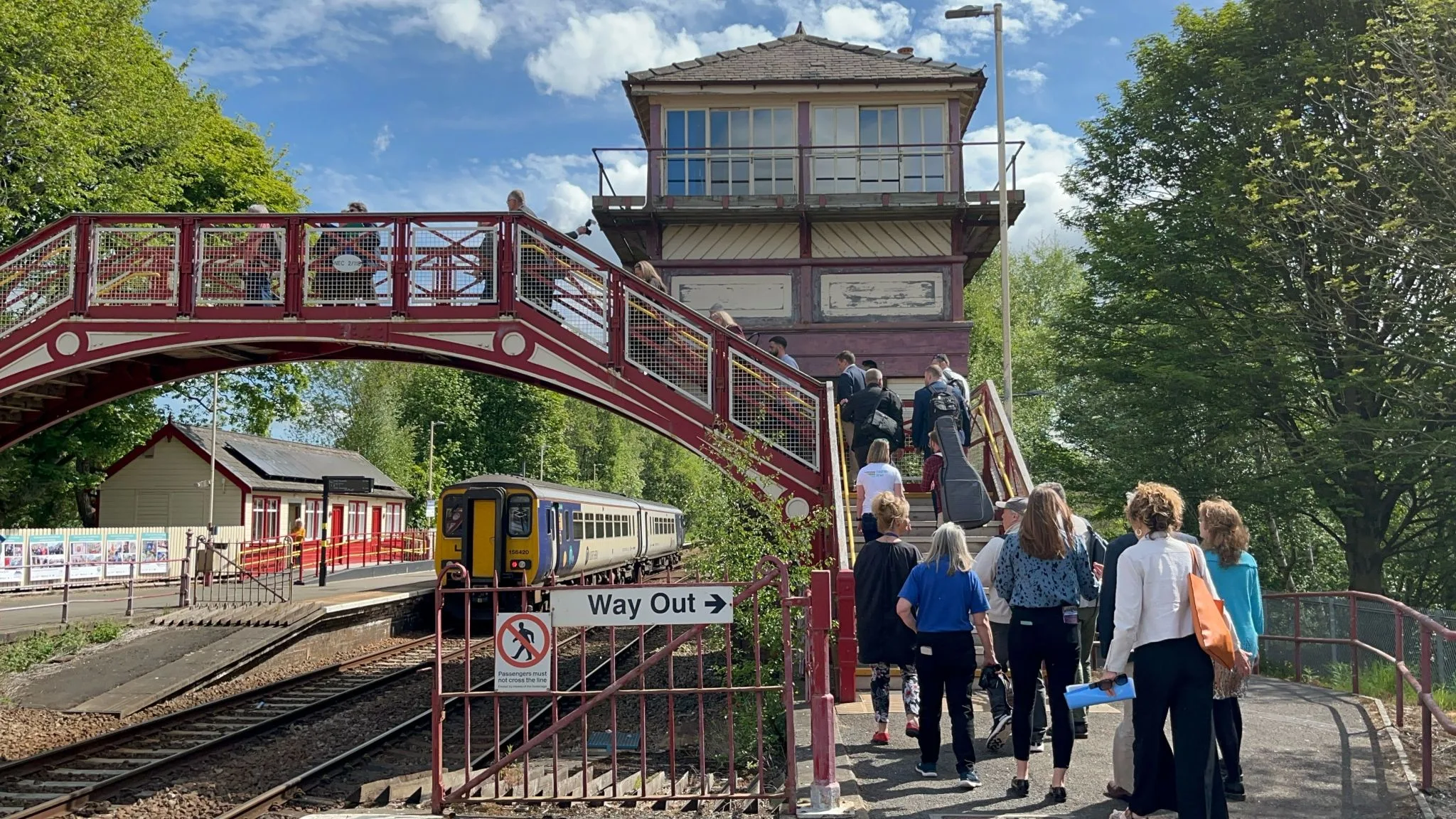 People walking across the bridge at Haltwhistle Station