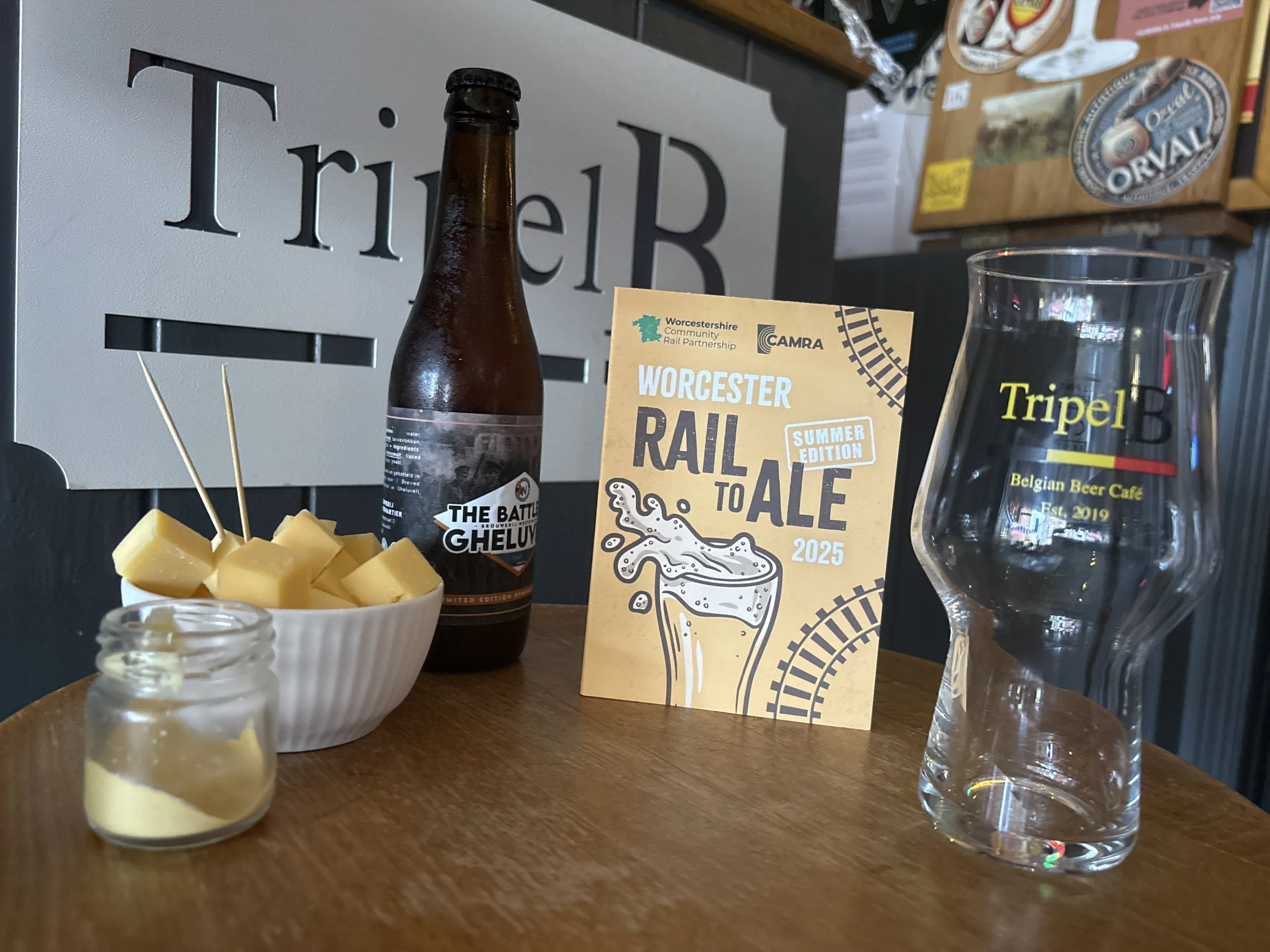 Ale and cheese on a table with the Rail to Ale Trail leaflet | Worcestershire Community Rail Partnership