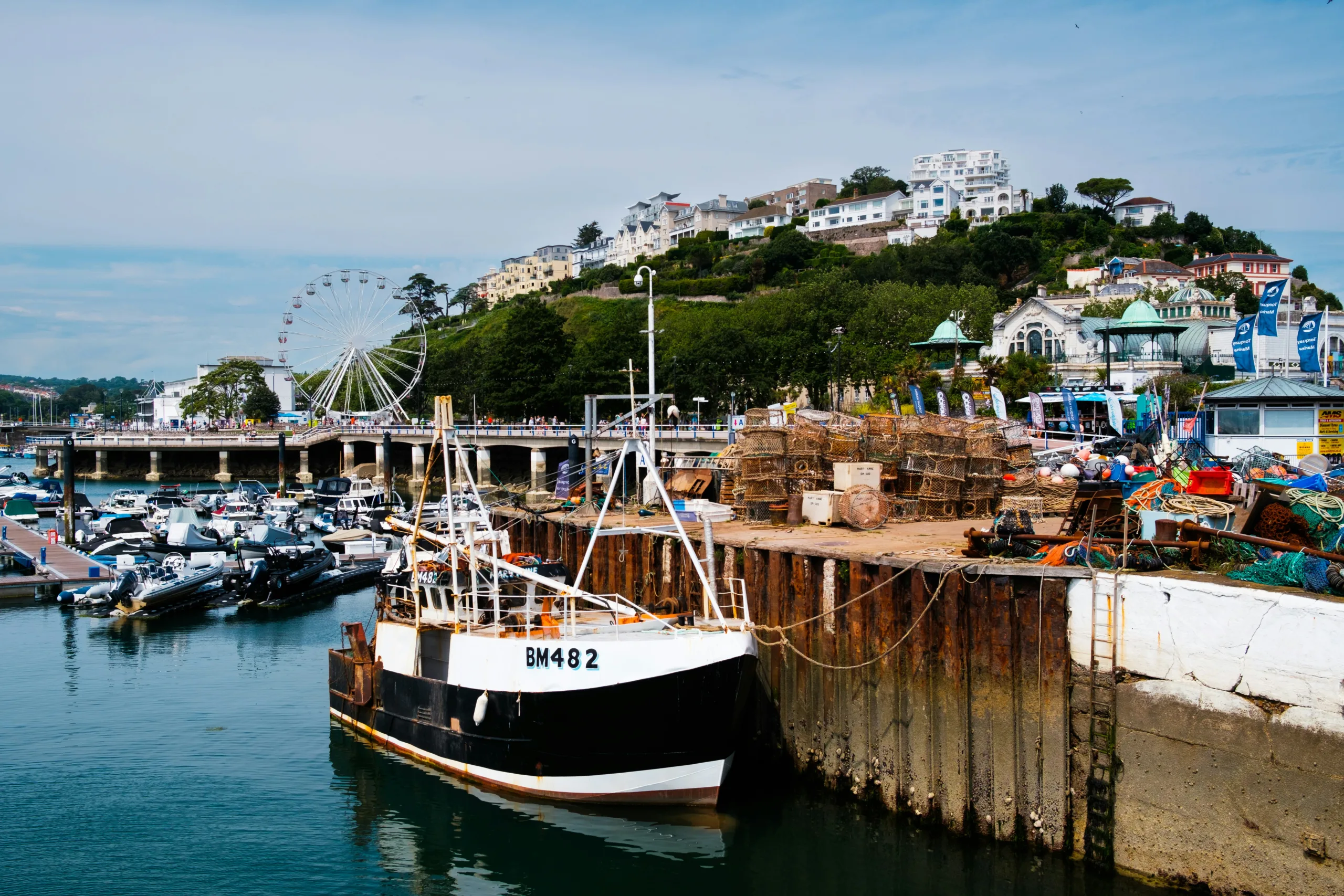 Boat with coastal resort in the background | Torquay