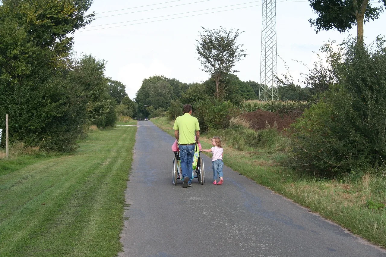 Family walking and wheeling in the countryside.