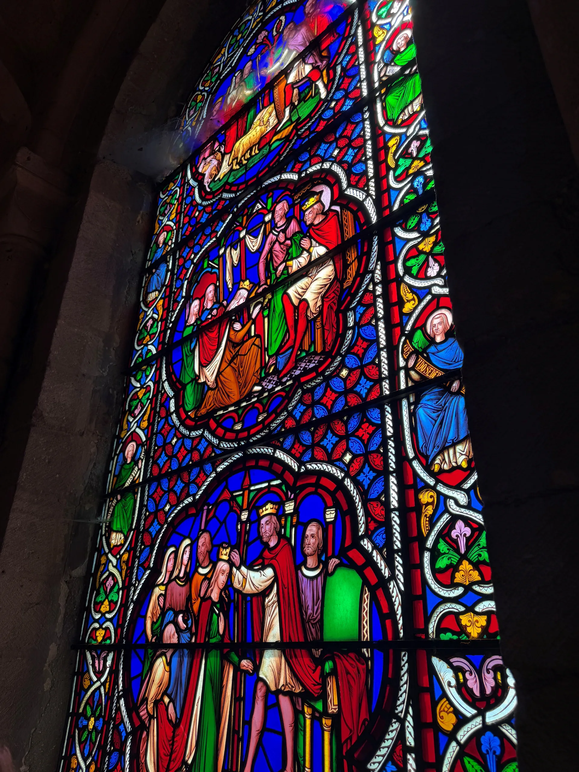 Close up view of colourful stained glass. Hereward Line.